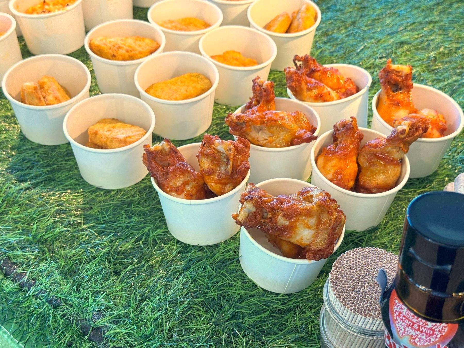 Chicken wings and nuggets arranged in individual snack cups