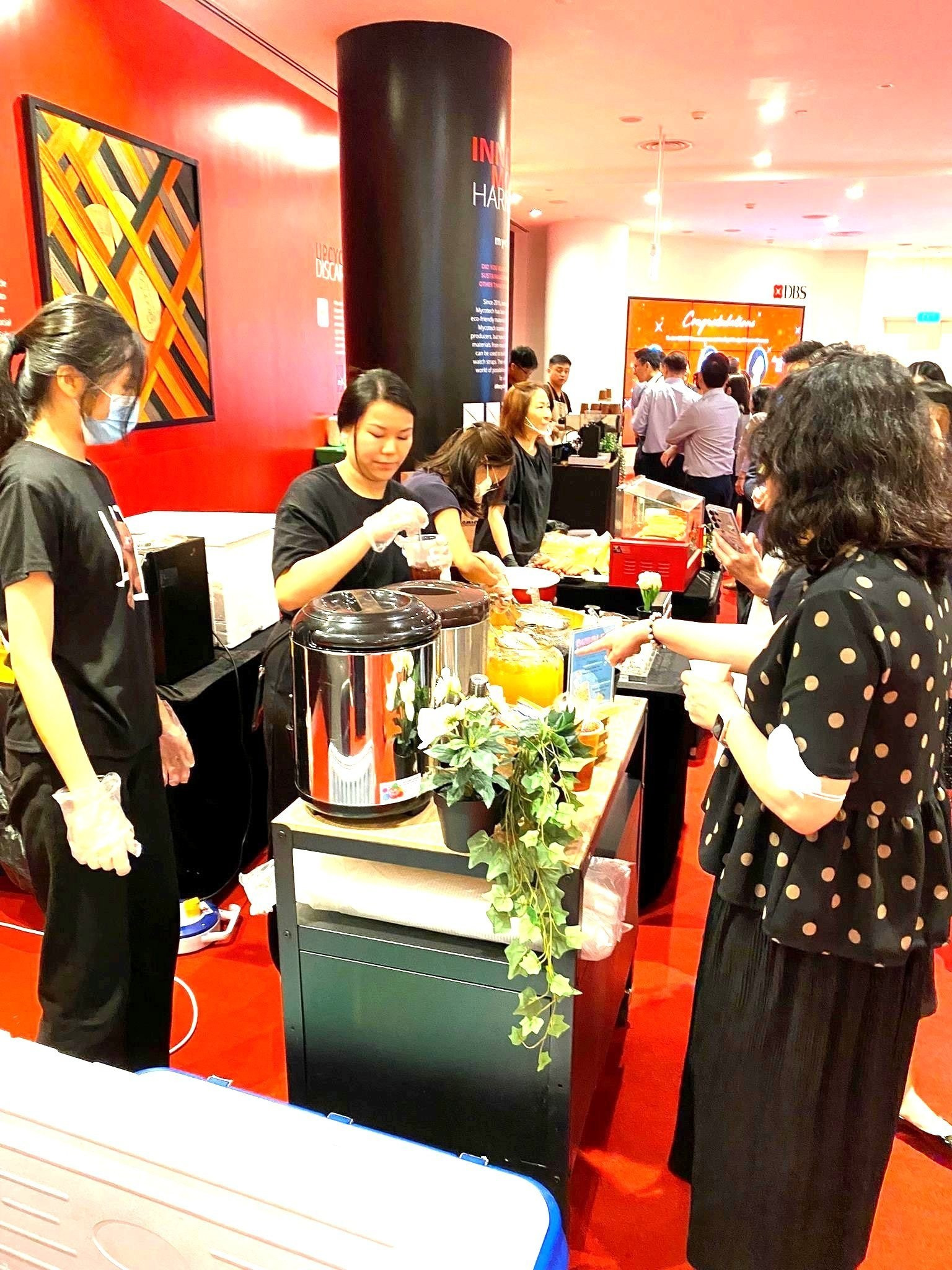 Guests collecting drinks from an attended corporate-event beverage station