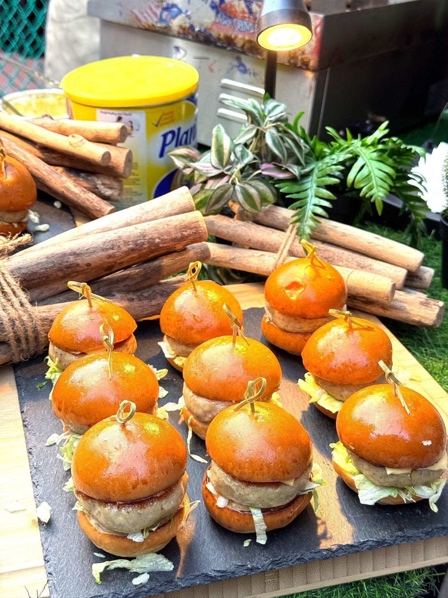 Mini burger sliders displayed on a slate serving board