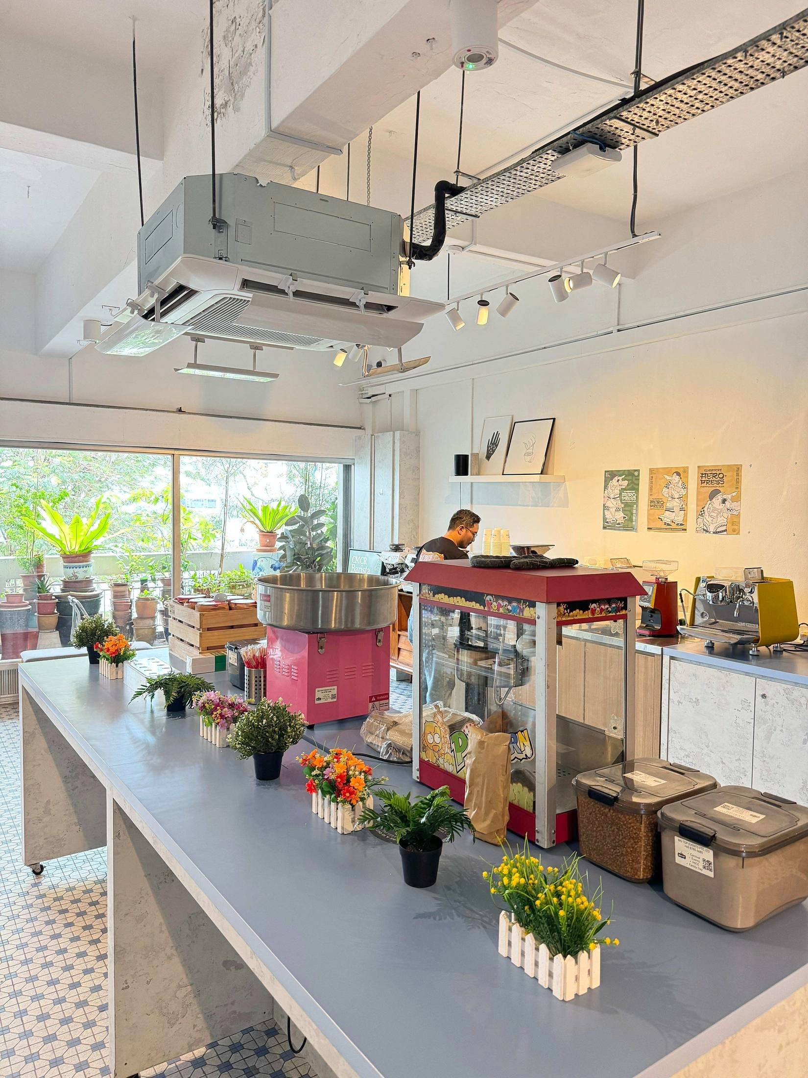 Popcorn and candy floss machines arranged on an indoor event counter