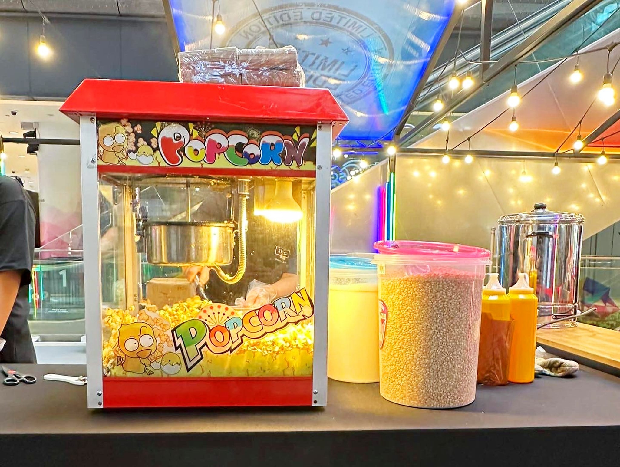 Popcorn machine and ingredients arranged on an event table