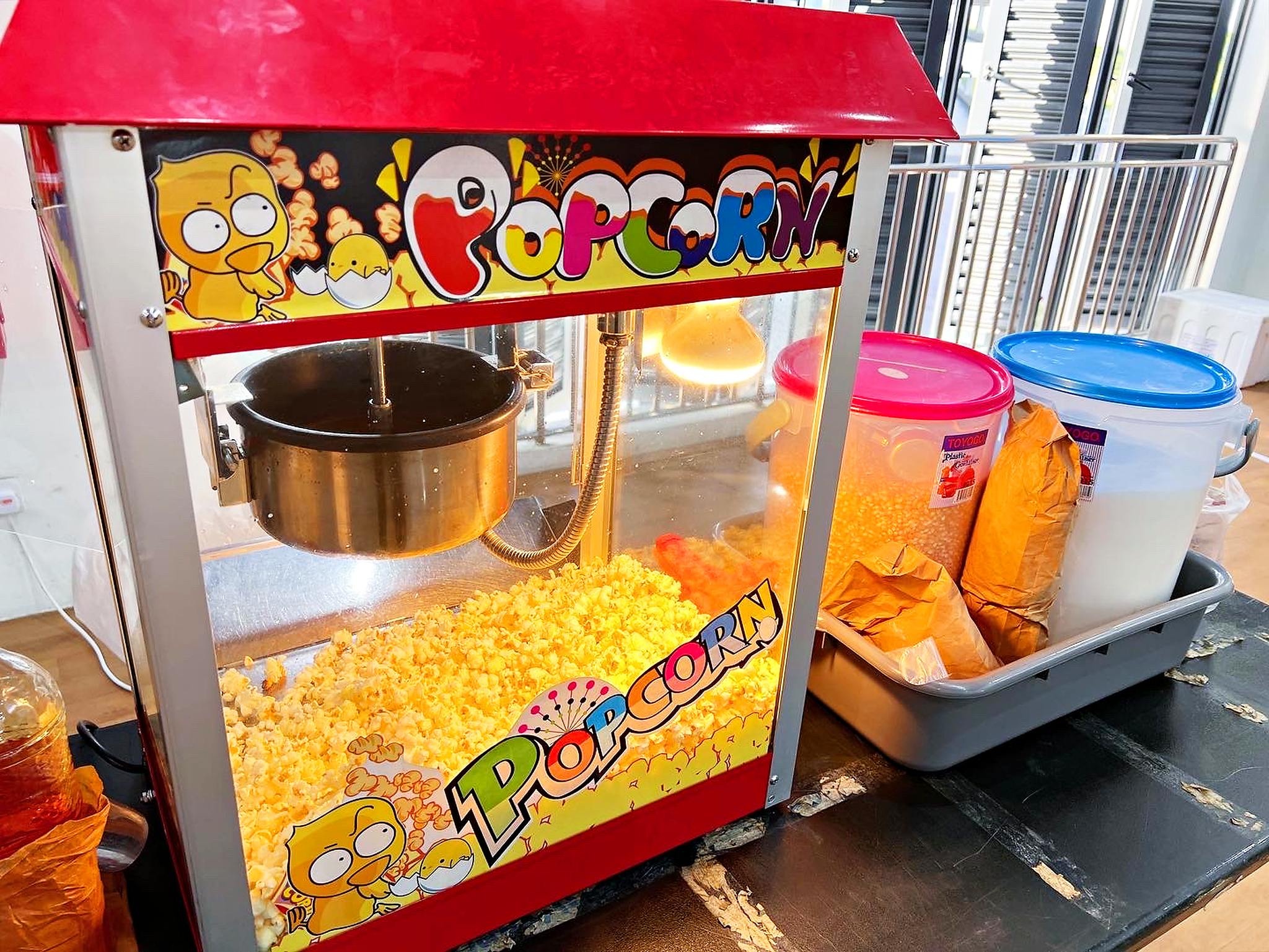 Fresh popcorn inside a lit serving machine