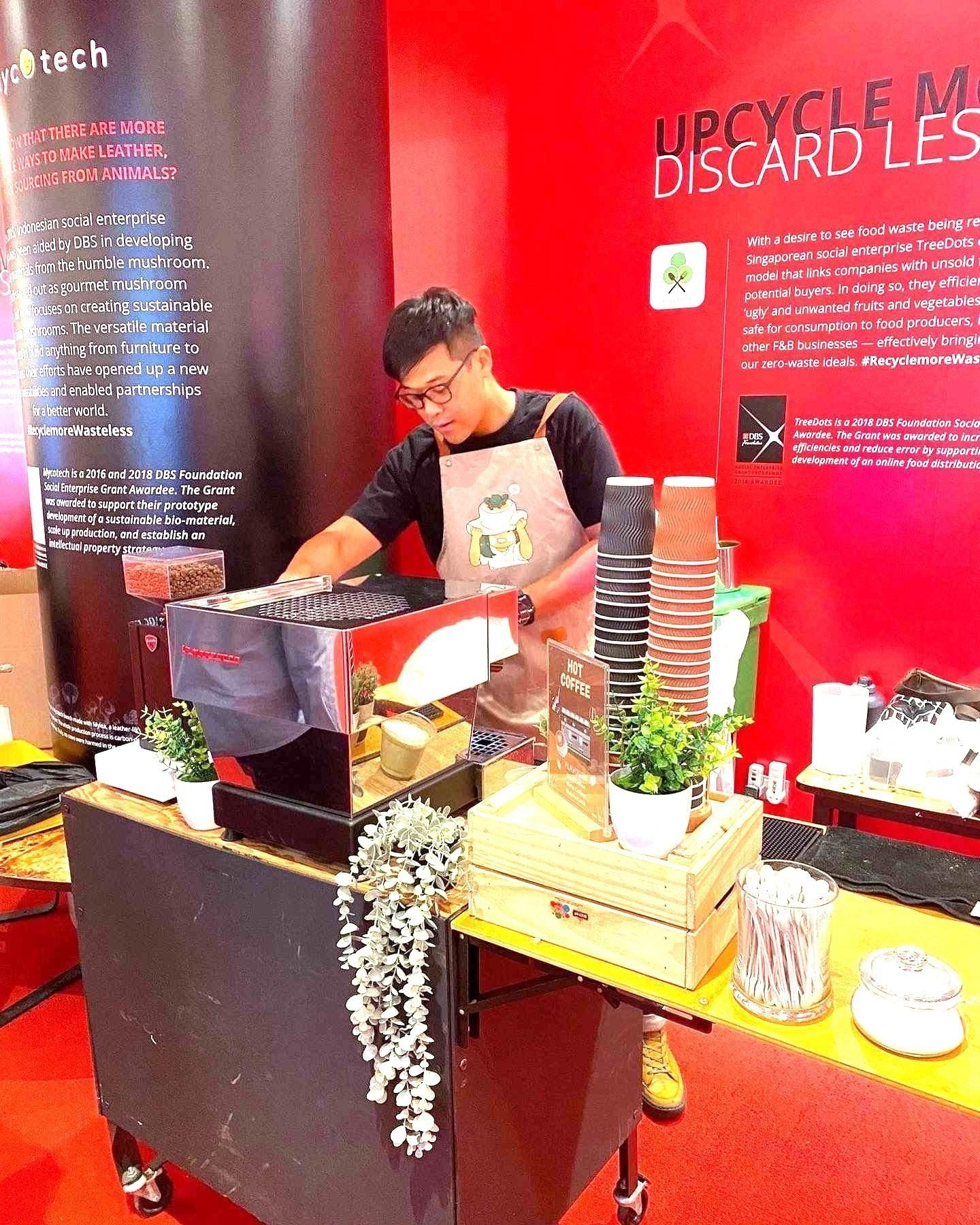 Barista coffee counter at an event with a red backdrop