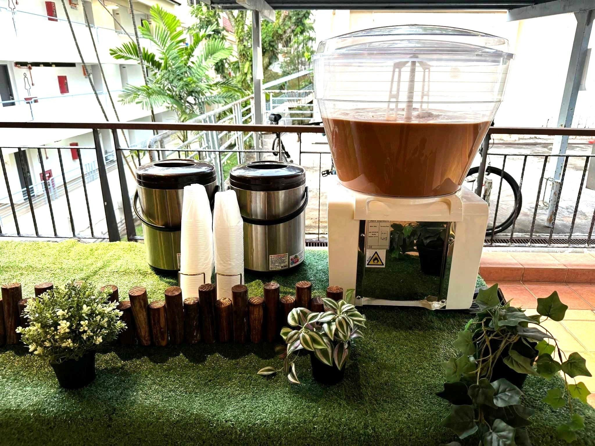 Chocolate drink dispenser alongside two metal urns