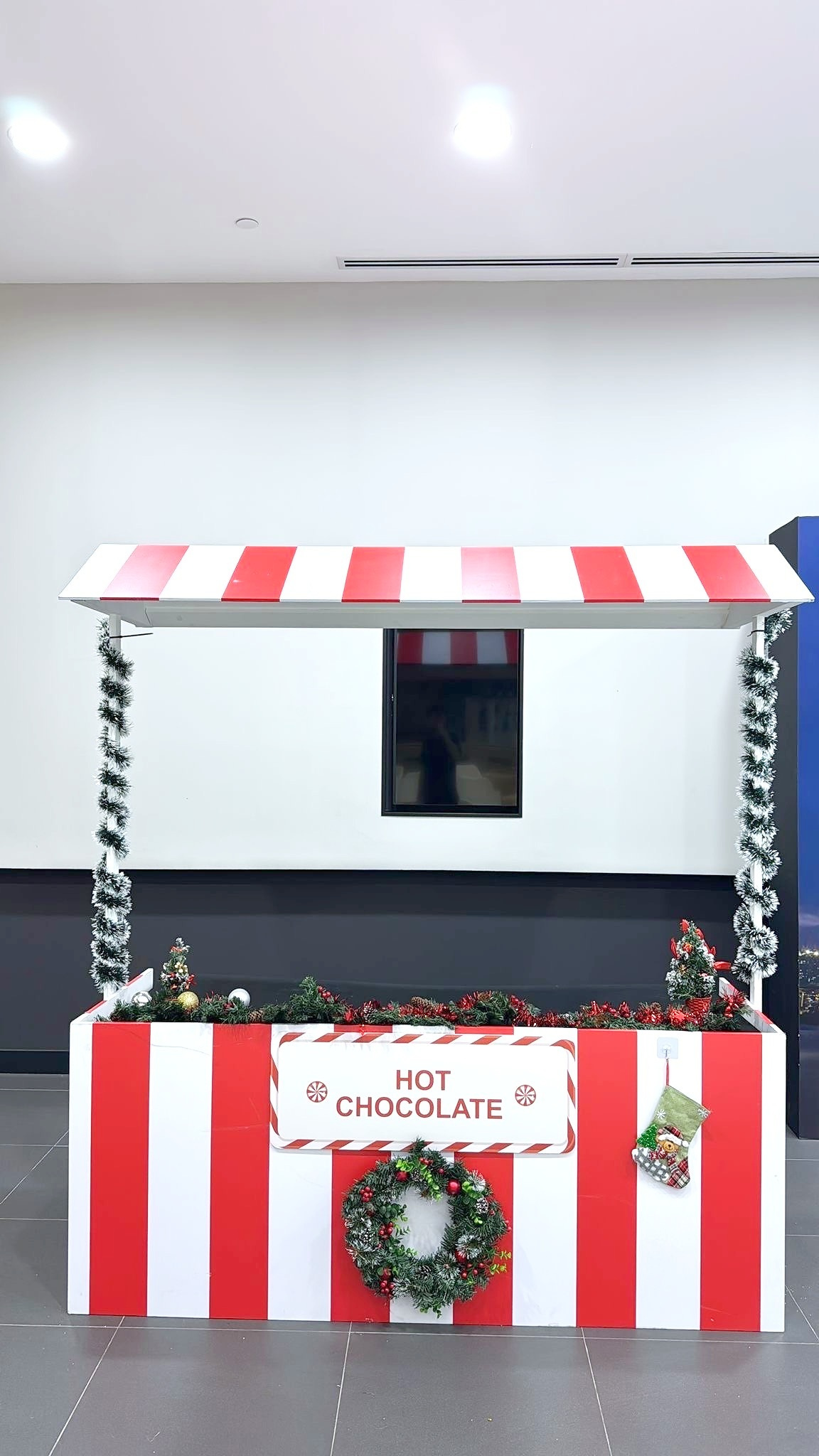 Christmas hot chocolate stall with red and white striped panels