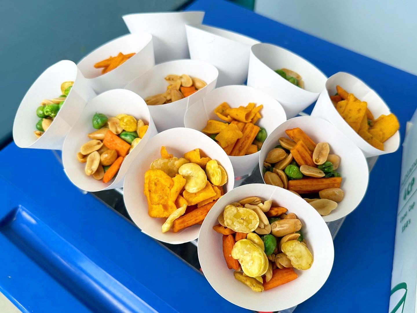 Paper cones filled with assorted kacang puteh snacks