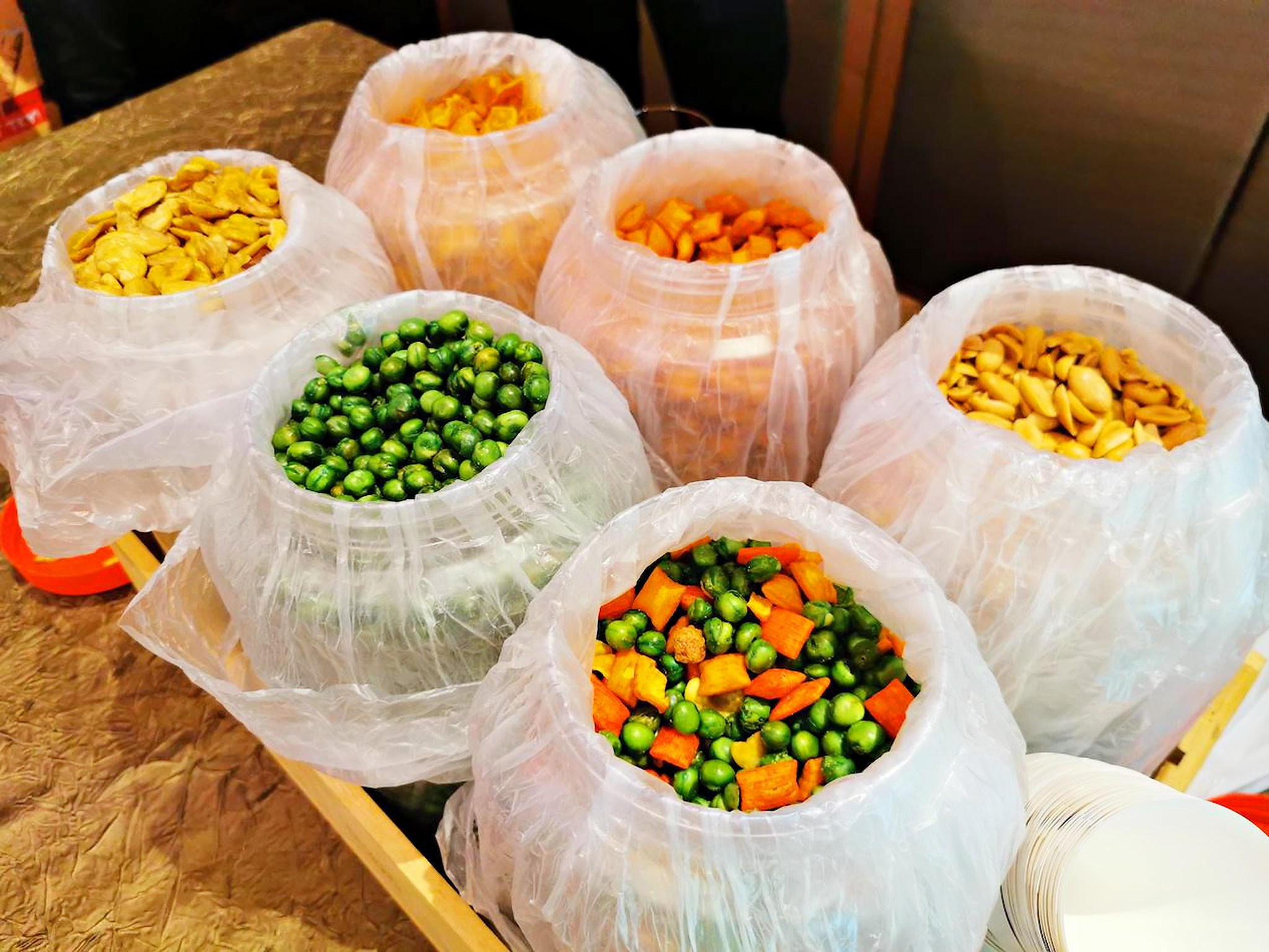 Assorted kacang puteh snack varieties in serving containers