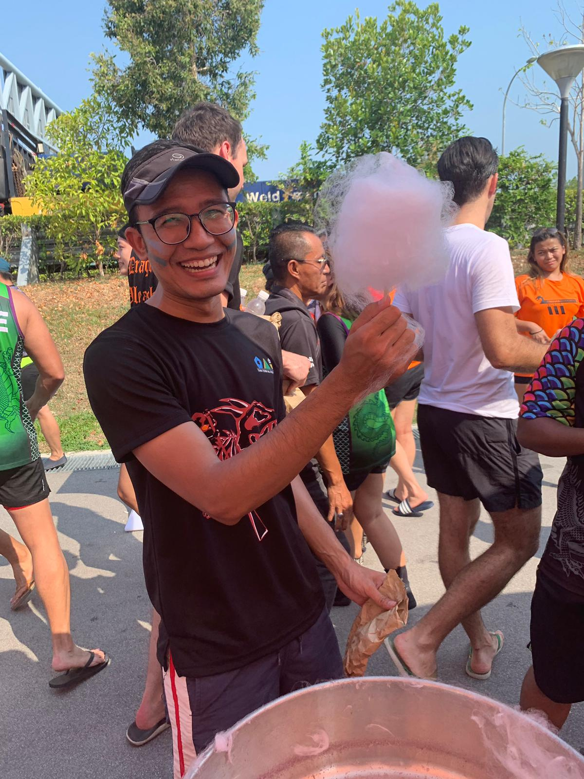 Guest holding freshly made pink candy floss outdoors