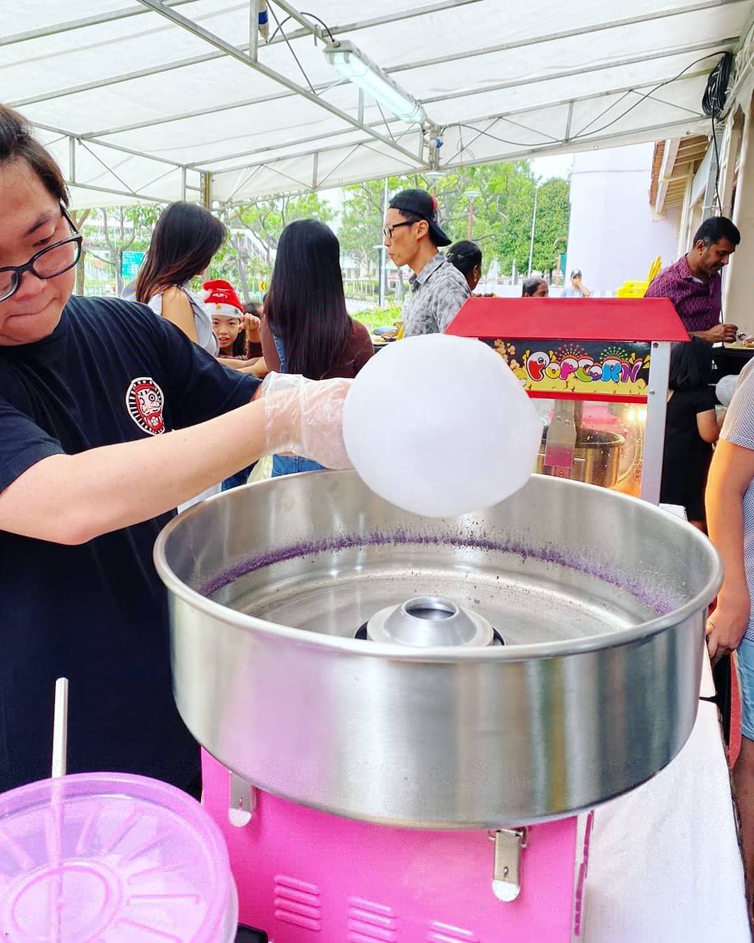 Candy floss operator at a covered event