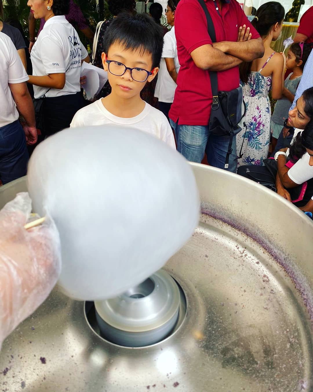 Blue candy floss being spun for a waiting guest
