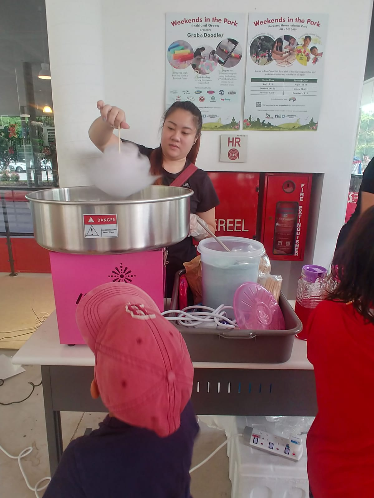 Candy floss machine and serving supplies at an indoor event