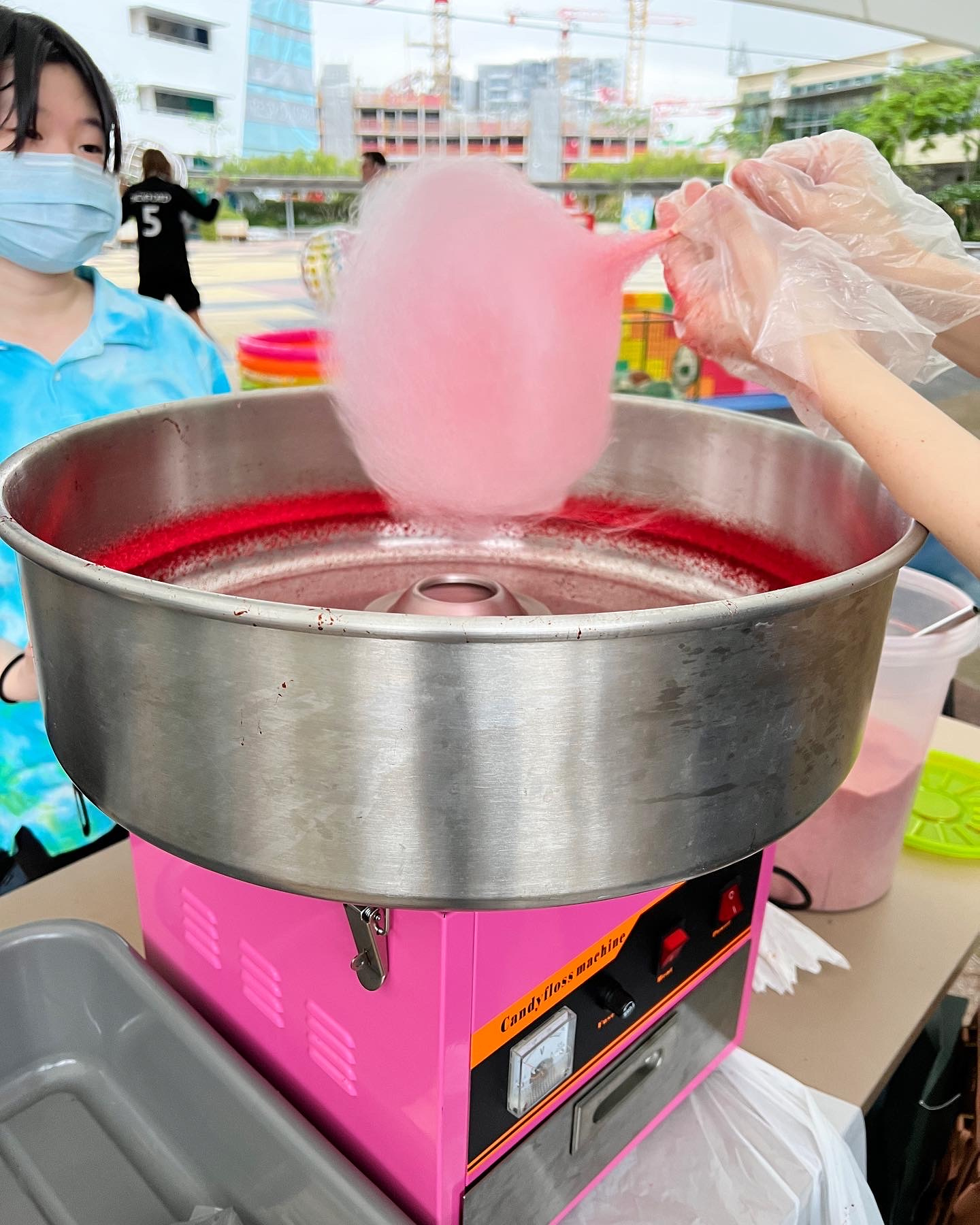 Fresh pink candy floss above a spinning machine