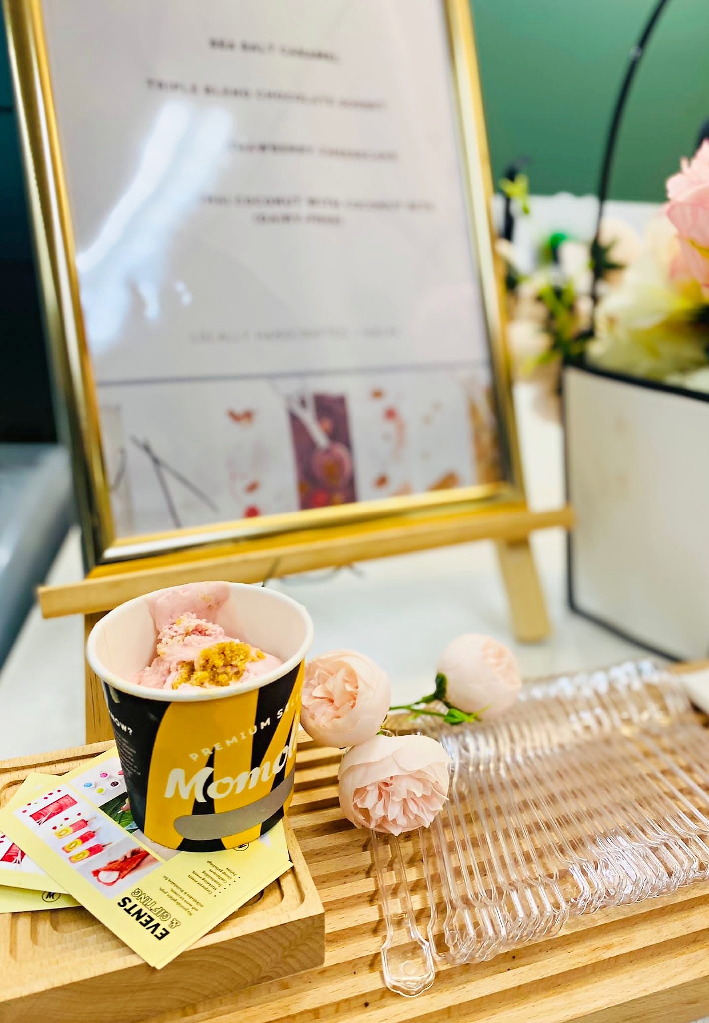 Momolato branded ice cream cup beside a serving display