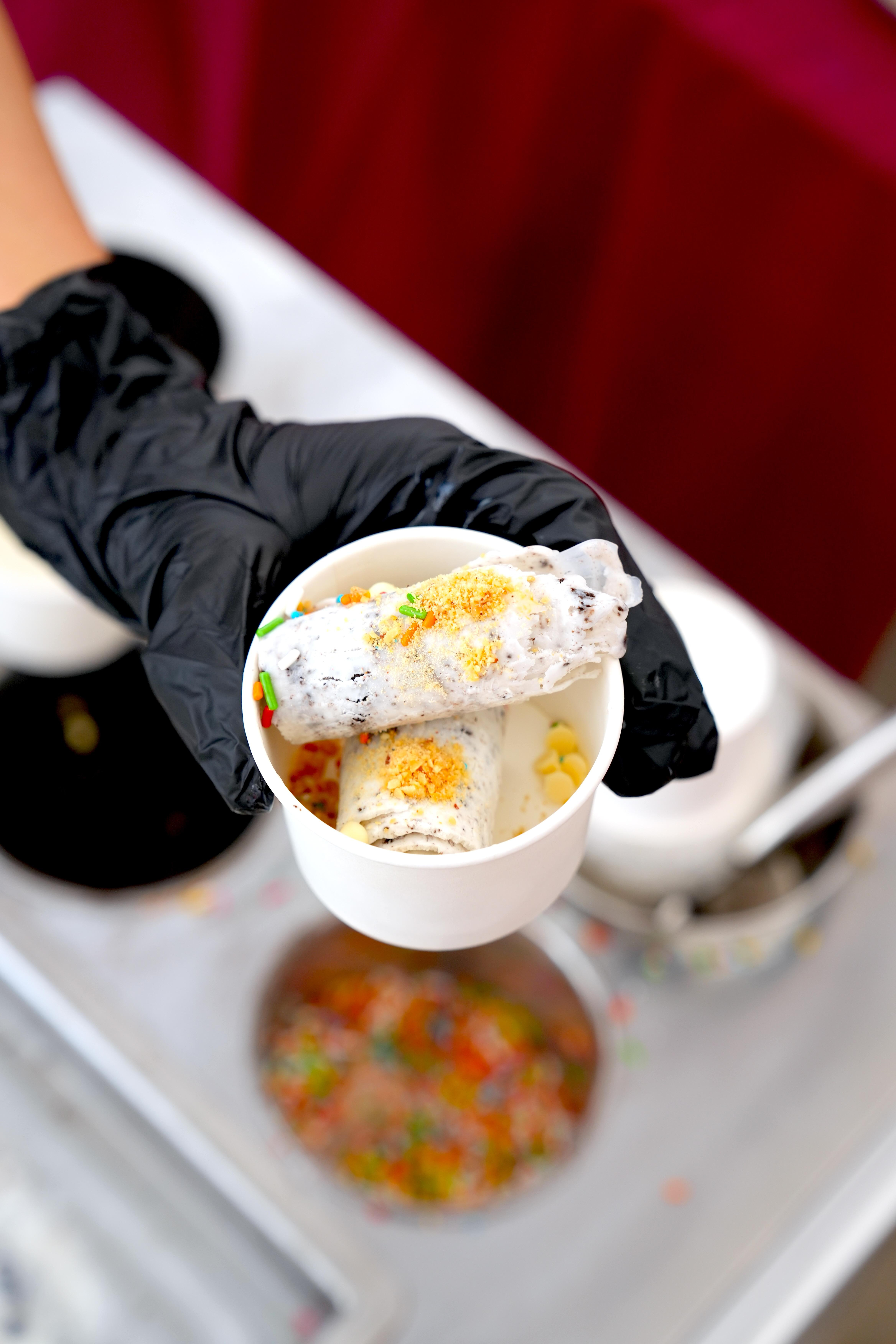 Ice cream live station serving freshly rolled ice cream with colourful sprinkles